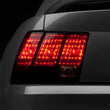 Load image into Gallery viewer, Raxiom 99-04 Ford Mustang Excluding 99-01 Cobra Tail Lights- Black Housing (Smoked Lens) - Main Product View