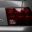 Load image into Gallery viewer, Raxiom 99-04 Ford Mustang Excluding 99-01 Cobra Tail Lights- Black Housing (Smoked Lens) - Installation View