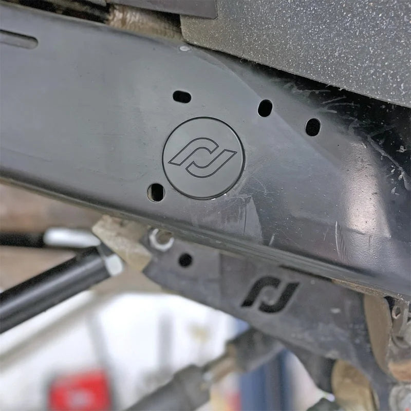 RockJock JL/JT Frame Rail Plugs Frame Behind Front Axle Centerline CNC Machined Black Delrin - Detail View