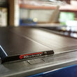 Load image into Gallery viewer, Roll-N-Lock 09-14 Ford F-150 67in E-Series Retractable Tonneau Cover - Back View