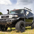 Load image into Gallery viewer, Rough Country 3 Inch Lift Kit | Red Spacers | Toyota 4Runner (03-09)/FJ Cruiser (07-14) 76530RED - Side View