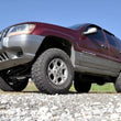 Load image into Gallery viewer, Rough Country 4 Inch Lift Kit | Jeep Grand Cherokee WJ 2WD/4WD (1999-2004) 698.20 - Installation View