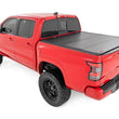 Load image into Gallery viewer, Rough Country Hard Tri-Fold Flip Up Bed Cover | 5' Bed | Nissan Frontier 2WD/4WD (22-26) - Installation View