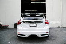 Load image into Gallery viewer, Seibon 12-13 Ford Focus 4 Door Carbon Fiber Tail Garnish - Installation View