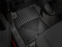 Load image into Gallery viewer, WeatherTech 08+ Nissan Xterra Front Rubber Mats - Black - Installation View